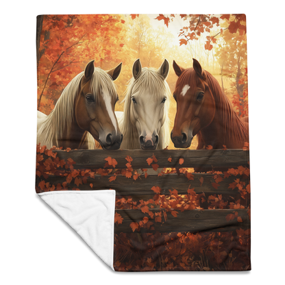Blanket showcasing three elegant horses standing behind a rustic wooden fence