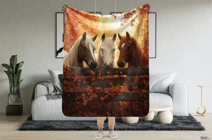 Blanket showcasing three elegant horses standing behind a rustic wooden fence